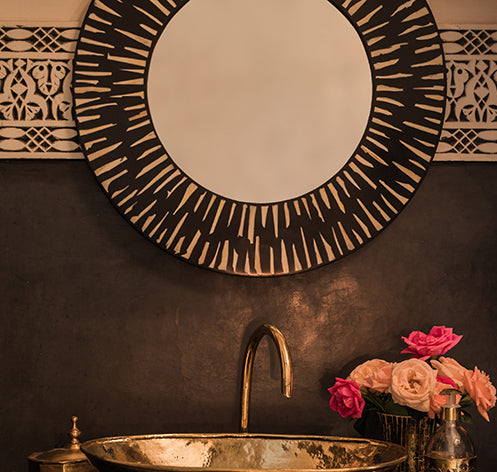 Inlaid mirror in black and white pattern.