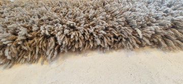Long-haired grey rug.