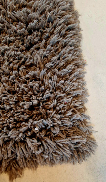 Long-haired grey rug.