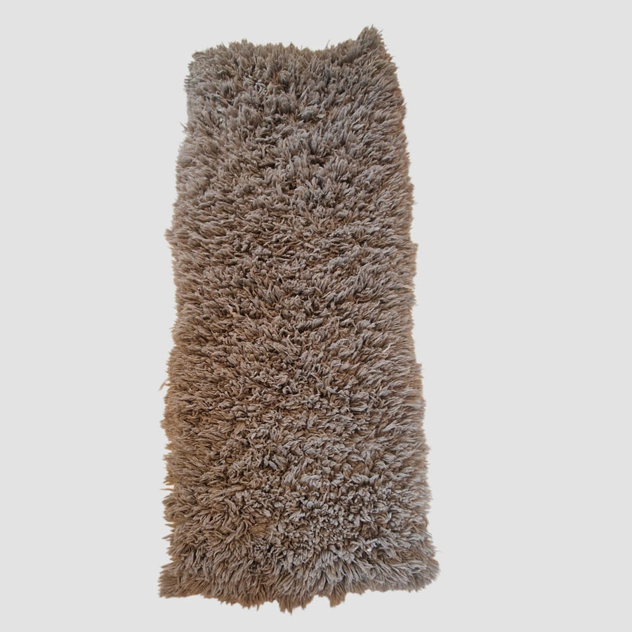 Long-haired grey rug.